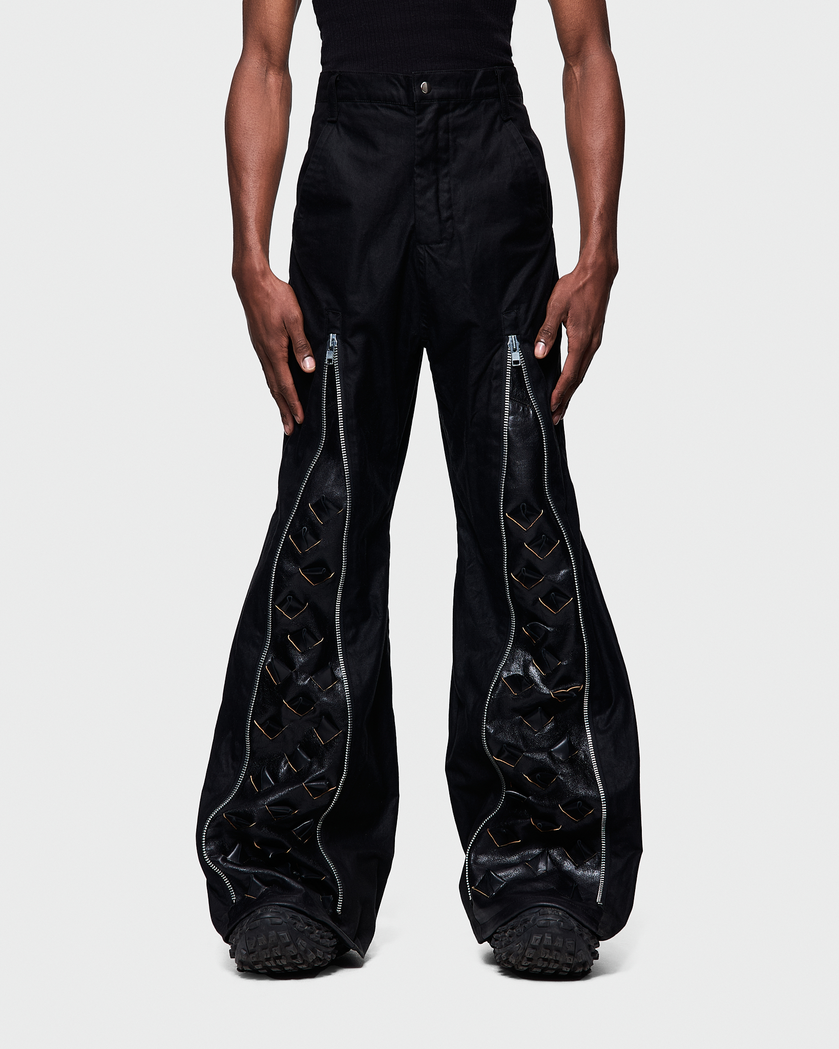 - Slim fit with bootcut leg<br />- Front feature an elogated zipper that reveals a croco 3-D leather panel